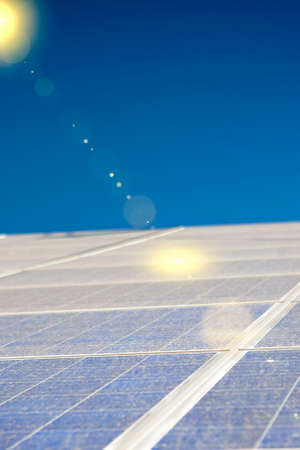 Alternative Energy Concepts: Solar Panels Array Against Blue Sky.Vertical Image Composition