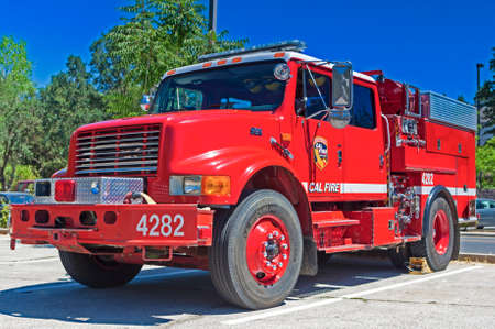 California-United States, July 12, 2014: Iconic Red Color American Fire Engine Equipped with Fire-Fighting Tools on Parking Place Stop on July 12, 2014 in California, United States Of America.のeditorial素材