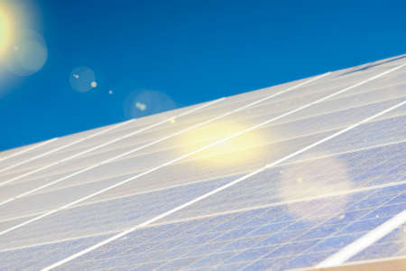 Alternative Energy Concepts: Solar Panels Array Against Blue Sky. Horizontal Image Composition