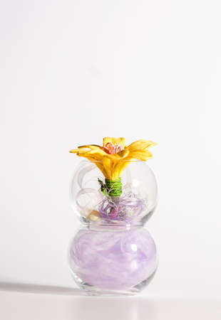 Artificial Decorative Flowers on Transparent Vase On Table.Vertical Image