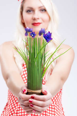 Pinup Caucasian Woman Holding Bunch of Vivid Lilac Flowers In Front.Vertical Image Compositionの写真素材