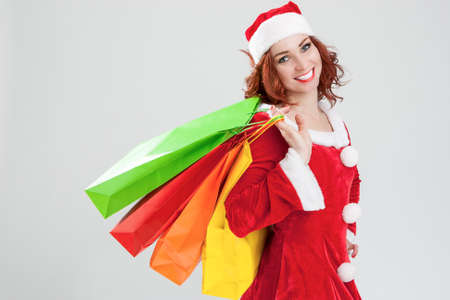New Year and Christmas Concept and Ideas. Portrait of Laughing Caucasian Red-Haired Santa Girl with...