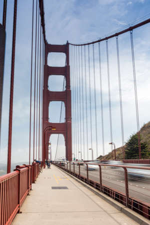 Blurred Trails of Cars and People Passing By on The Golden Gate Bridge in San-Francisco in the...