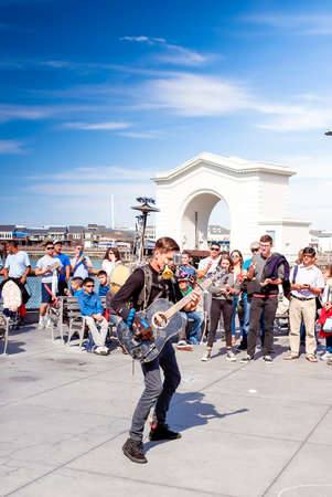 San-Francisco-United States, July 13, 2014: Positive Caucasian Male Multiplayer Musician Performing Outdoors on San-Francisco Pier on July 13, 2014 in San-Francisco, California, United States of Americaのeditorial素材