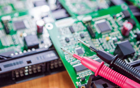 Laboratory Components and Staff. Pins of Digital Multimeter In Front of Printed Circuit  Boards with Integrated Circuitry. Horizontal  Imageの写真素材