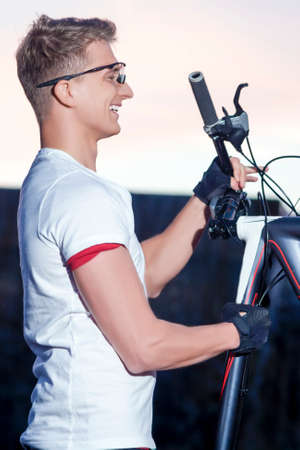 Cycling Concept and Ideas. Handsome Sportive Caucasian Cyclist With MTB Bike Outdoors. Vertical Image Orientationの写真素材