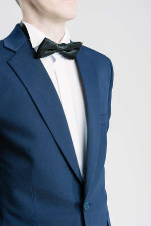 Closeup Portrait of Young Caucasian Man in Blue Suite and Bow Tie. Vertical Shotの写真素材