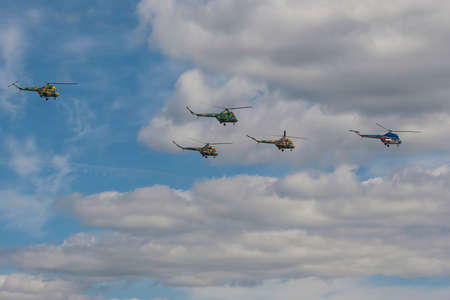 Minsk, Belarus-June 21, 2014: Team of MI-2 Helicopters Performing Elements in Air In Front of Spectators During Aviation Sport Event Dedicated to the 80th Anniversary of DOSAAF Foundation in Minsk on June 21, 2014 in Minsk, Republic of Belarusのeditorial素材