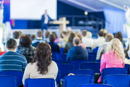 Lecturer Speaking In front of the Large Group of People. Horizontal Image Composition