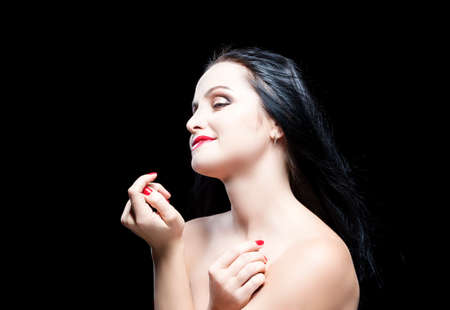 Sensual and Dreaming Caucasian Brunette Woman. Posing Against Black. Horizontal Imageの写真素材