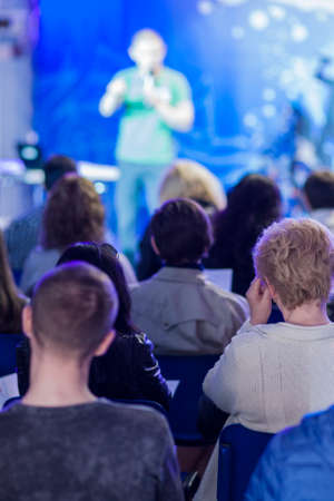 Male Professional Lecturer Speaking In front of the People. Horizontal Image Composition. Vertical...
