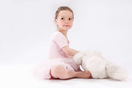 Cute Little Caucasian Child with Big Plush Toy. Sitting and Looking Upwards. Horizontal Image Orientationの写真素材
