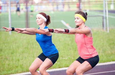Sport Concepts and Ideas. Two Professional Female Athletes Having Training At Sport Venue Outdoors....