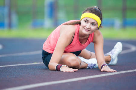 Sport Concepts and Ideas. Caucasian Brunette Female in Athletic Sportgear Having Legs Stretching ...