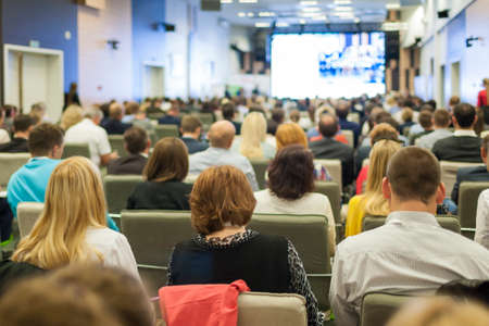 Large Group of People on a Conference. Watching Business Presentation on a Big Screen in Front. Horizontal Imageの写真素材