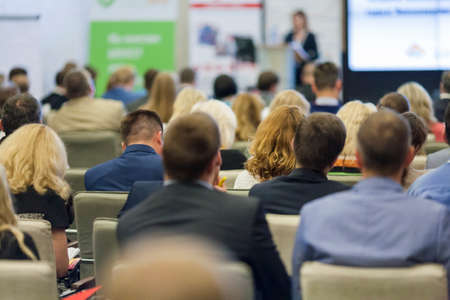 Professional Female Host Speaking in Front of the Audience During Business Conference.Horizontal Image Compositionの写真素材