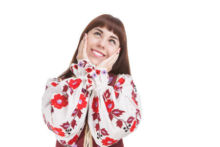 Natural Portrait of Caucasian Brunette Female Posing in National Flowery Dress. Showing Exclamation...