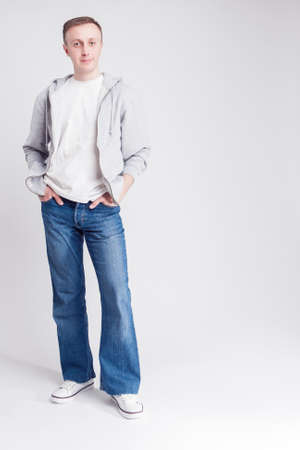 Full Length Portrait of Happy Caucasian Man in Casual Clothing Posing Against White Background. Vertical Image Compositionの写真素材