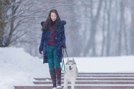 Portrait of Pretty Smiling Woman Walking with Her Dog Outside. Horizontall Image Compositionの写真素材