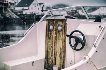Front View of Upper Deck with Steering on Small Yacht Moored to Pier at Lofoten Islands in Norway.Horizontal Imageの写真素材
