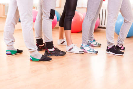 Closeup of Feet of Five Female Athletes Posing Together in Sport Venue.Horizontal Image Composition