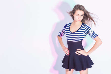 Youth Lifestyle Ideas and Concepts. Portrait of Positive Caucasian Brunette Girl In Trendy Striped...
