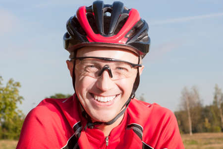 Portrait of Positive caucasian Male Road Cyclist Posing Outdoors in Helmet and Sport Outfit.Horizontal Imageの写真素材