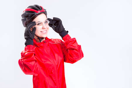 Sport Concepts and Ideas. Portrait of Smiling Caucasian  Female Cycling Athlete Posing Equipped in Professional Outfit in Studio. Horizontal Image Compositionの写真素材