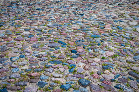 Closeup of Old Ancient Belatussian Pavement Made of Paving Stones. Originally  Was Founded in the Beginning of 20 Century. Located in Braslav City in Belarus.Horizontal Imageの写真素材
