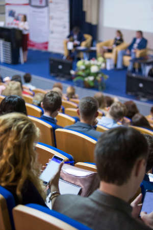 Business Conferences Concept and Ideas. Back of Congress Participants Listening to The Lecturer Speaking In front of the Group of People. Vertical Image Compositionの写真素材