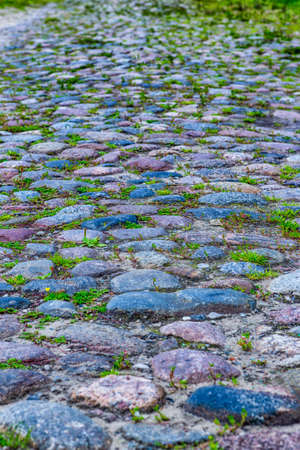 Closeup of Old Ancient Belatussian Pavement Made of Paving Stones. Originally  Was Founded in the Beginning of 20 Century. Located in Braslav City in Belarus. Vertical Shotの写真素材