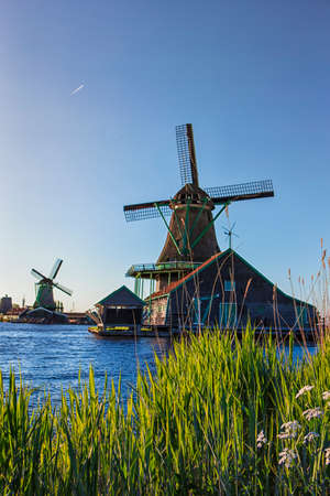 Travelling Ideas. View of Traditional Wooden Dutch Windmills at the Zaan River in Zaanse Schans, Holland, The Netherlands. Vertical  Imageの写真素材