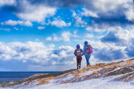 Travel Ideas.Mountain Destinations. People Travelling Through the Mountains of Lofoten Islands in Norway.Horizontal Imageの写真素材
