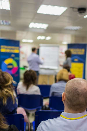 Business Meetings. People Attending a Conference. Listening to the Presenter In Front of a Group of...