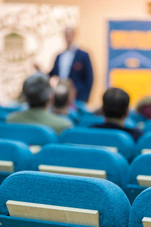 Business Concepts. Group of People Listening to a Lecturer Standing In Front of A Screen During a Conference.Vertical Image Compositionの写真素材
