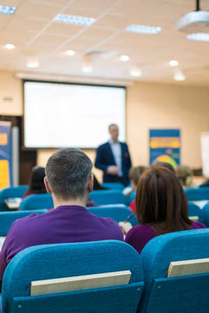 Conferences and Business Meetings Concepts. Mature Experienced Male Presenter Giving a Talk in Front...