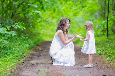 Portrait of Young Caucasian Family Couple Posing Together In Green Summer Forest.Positive Facial Expression. Horizontal Imageの写真素材