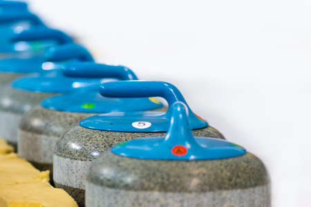 Sport Concepts. Closeup of Curling Blue Handle Stones on Ice.With Copyspace. Horizontal Image...