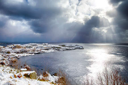 Norwegian Destinations. Picturesque View of Sunlight Going Through The Clouds Before the Sunset at...