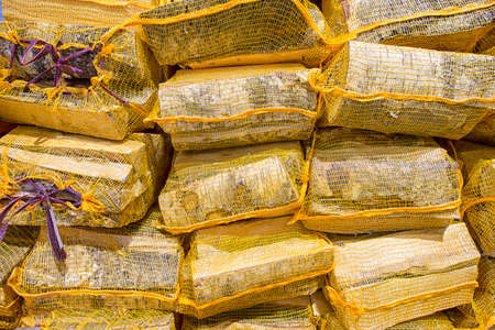Meshy Sacks of Woodpiles Stacked Together Very Closely. Horizontal Image Compositionの写真素材