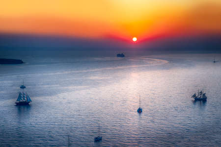 Sailing Boats and Cruise Ships Near Santorini Island at Dus. Picture Taken at Golden Hour.Horizontal...