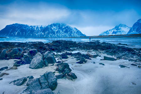 Silhouettes of Two Men Making Pictures At Picturesque Norwegian Skagsanden Beach At Early Spring Time.Horizontal Image Orientationの写真素材