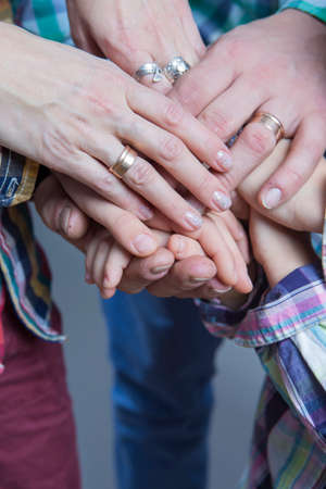 Closeup View of Young Caucasian People Connecting Their Hands Together. Stack of Five Pairs of Hands...