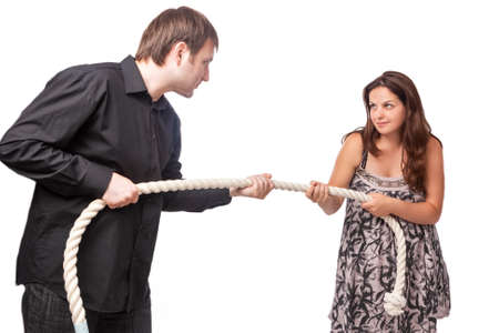 Young Caucasian Couple Towing a Rope To Each Other. Concept of Separation and Divorce.Horizontal Image Compositonの写真素材