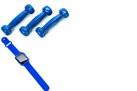 Sport Concepts. Three Barbells with Fitness Watch Placed Together on White Surface. Copyspace image....