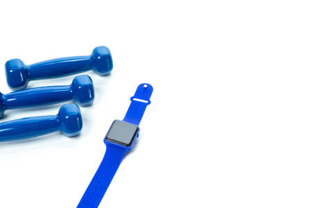 Sport Concepts. Three Barbells with Fitness Watch Lay Together on White Surface. Copyspace image.Horizontal Orientationの写真素材