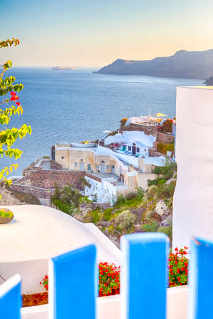 European Destinations. Amazing View of Classic White Houses and Blue Gates of Oia Village Houses on Santorini Island in Greece. Vertical Image Compositionの写真素材
