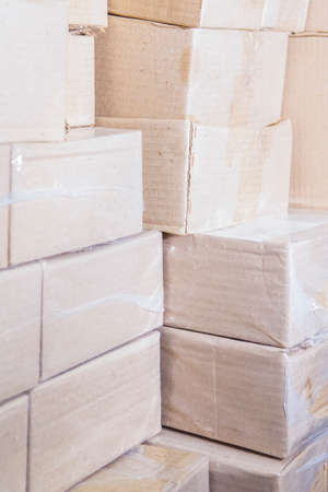 Plenty of Packaging Boxes Sealed with Plastic Bags.Vertical image