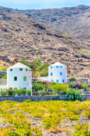 Travel Destinations. Traditional Round Greek  Mill Houses on Santorini Island on Caldera Mountains....