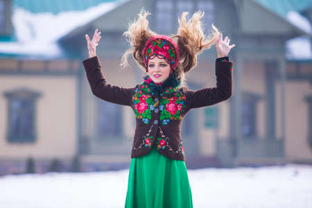 Winter Female Fashion Concepts. Happy Caucasian Blond Girl in Stylish Green Dress and Kokoshnik....